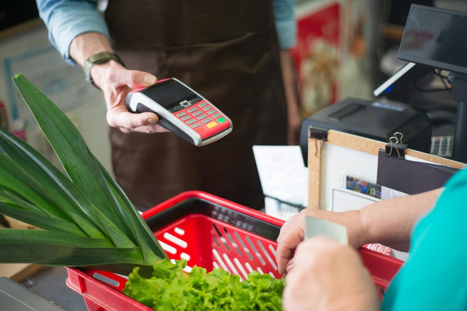 Modern grocery store checkout area with multiple lanes and scanning equipment