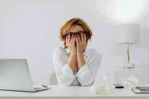 Stressed business professional at desk highlighting workplace mental health challenges