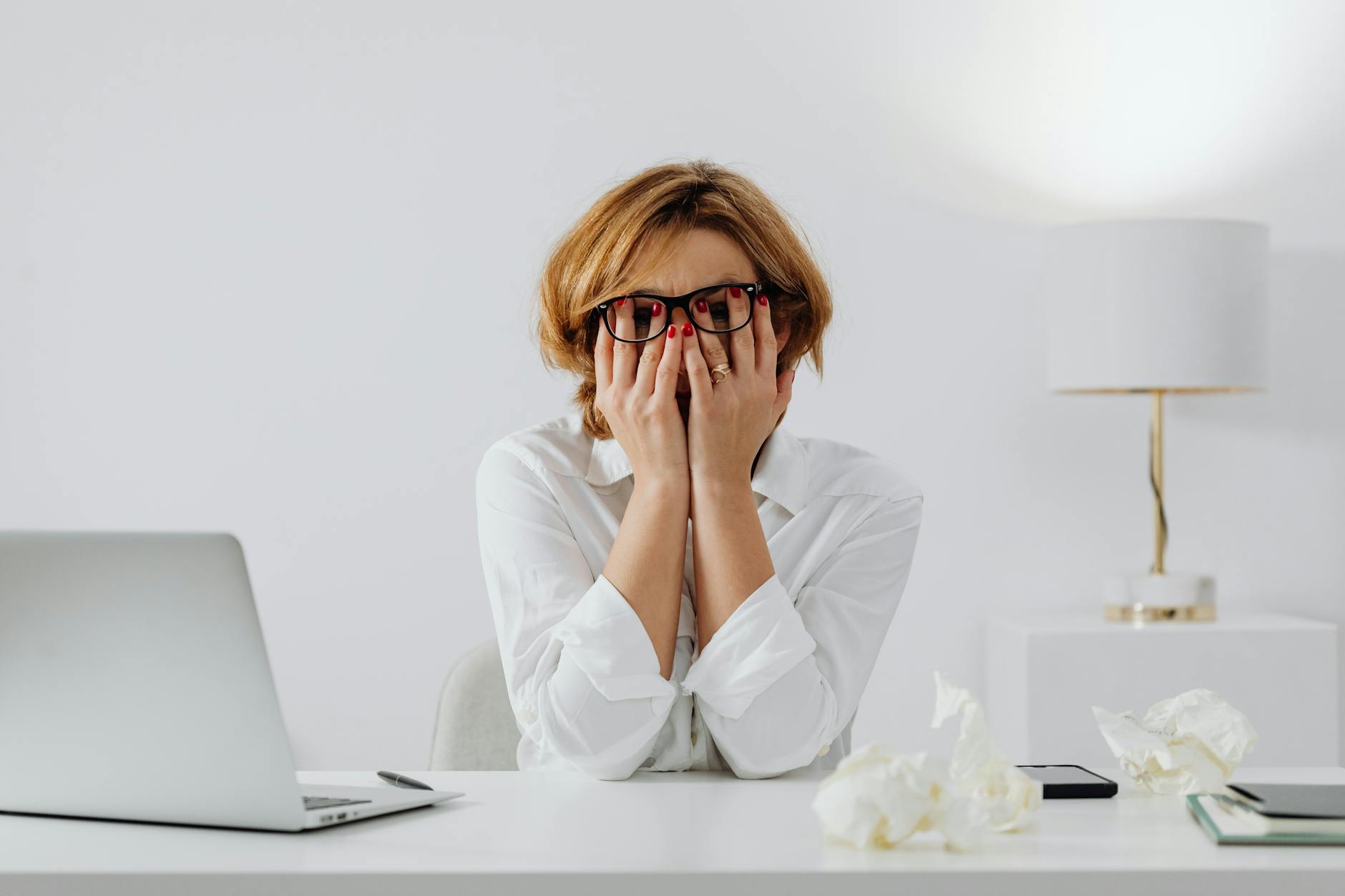 Stressed business professional at desk highlighting workplace mental health challenges