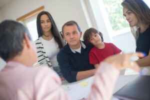 Financial advisor meeting with family to discuss investment planning and wealth transfer strategies