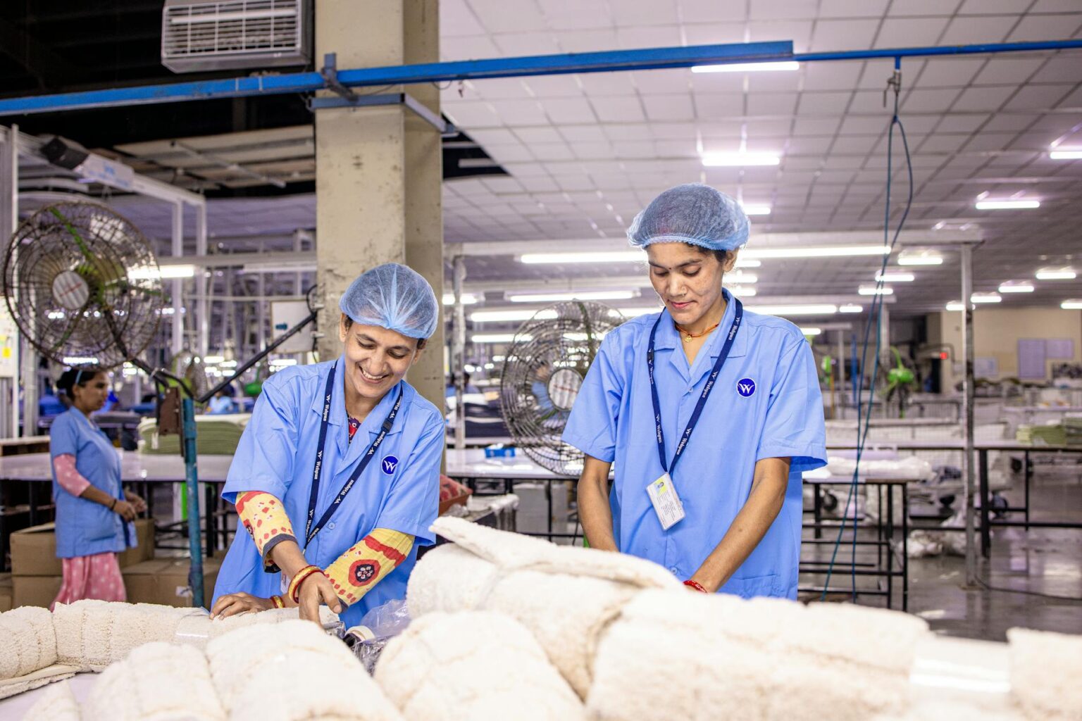 Industrial workers in manufacturing facility during shift change