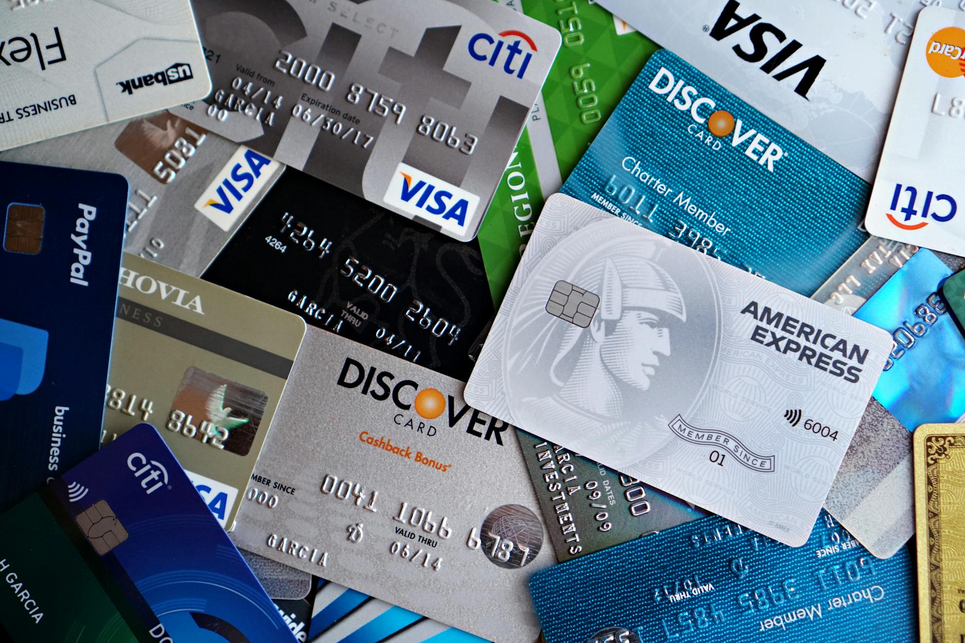 Professional businessperson holding corporate credit cards at modern office desk