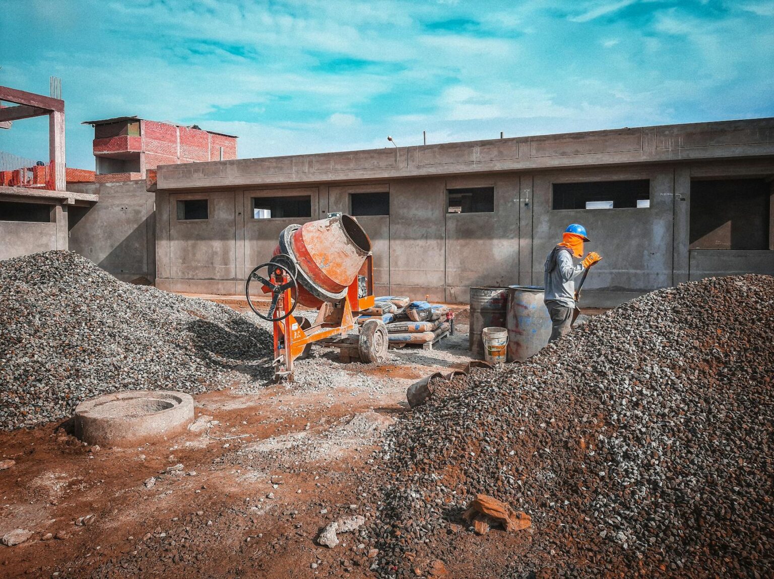 Construction worker in hard hat and safety vest working on building site