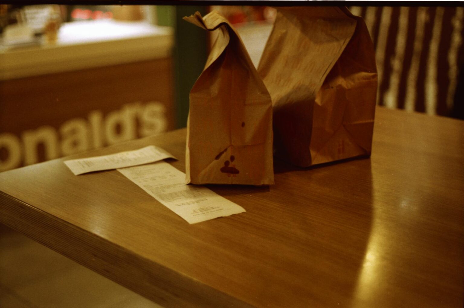 Interior view of modern fast food restaurant with digital ordering kiosks and contemporary design