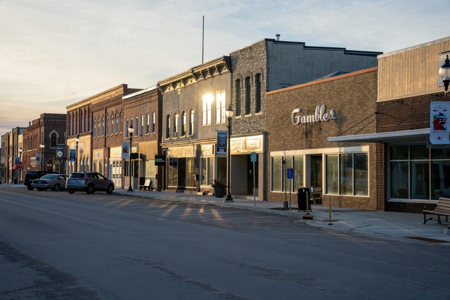 Charming main street of a small American town with local businesses and tree-lined sidewalks