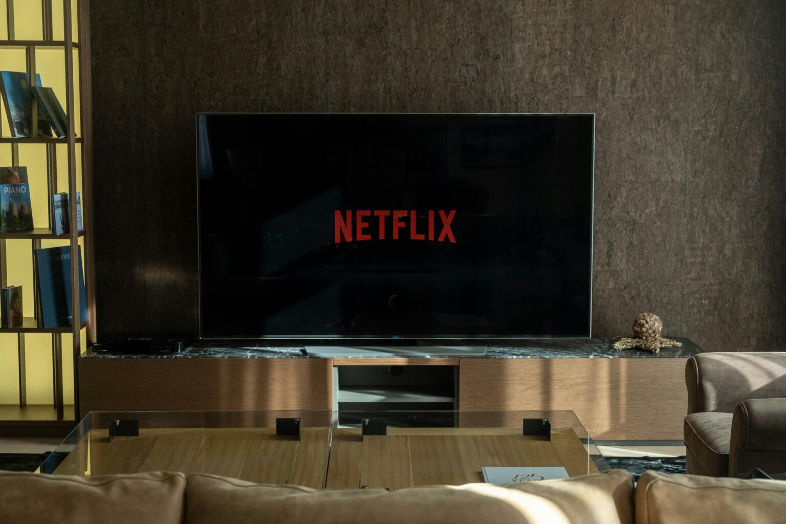 Person watching streaming content on television in modern living room