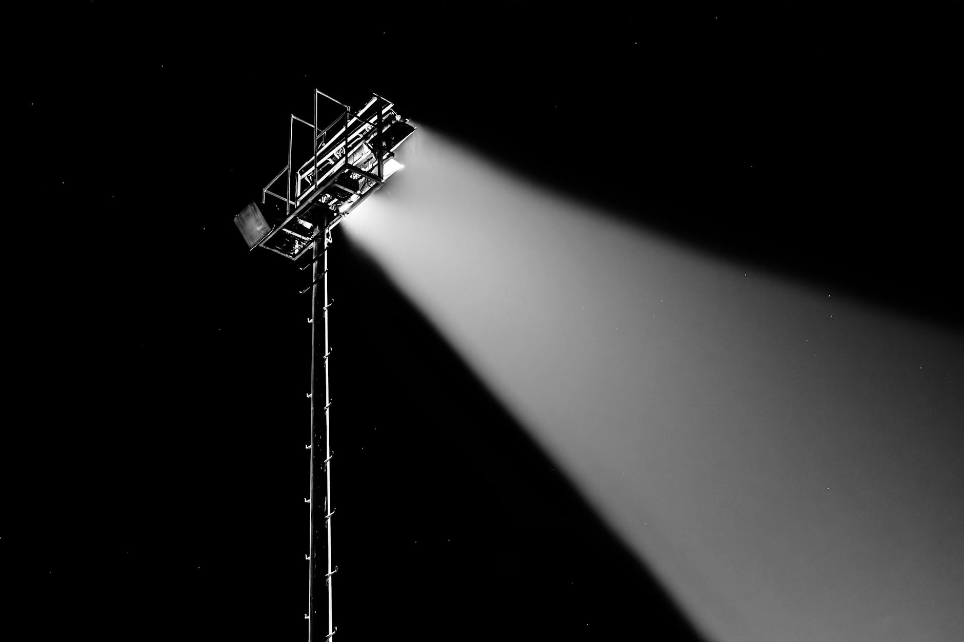 Bright stadium lights illuminating a sports venue at night