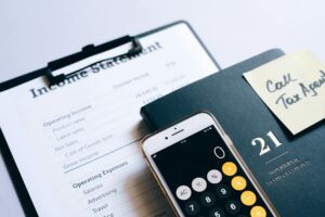 Financial planning documents and calculator on desk representing retirement investment strategy