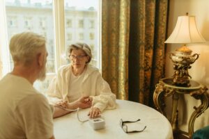 Elderly person receiving care at home from healthcare worker