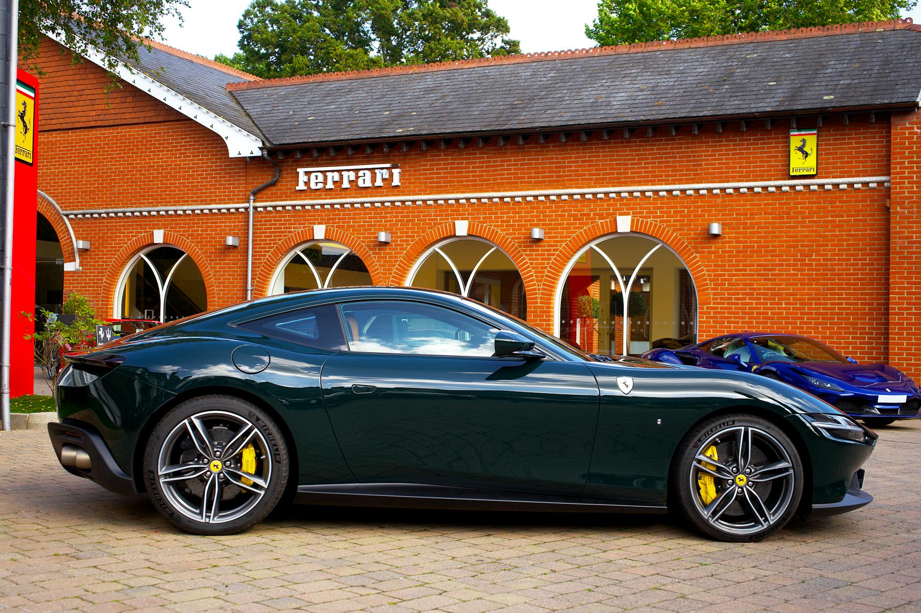 Modern luxury car showroom with premium vehicles on display