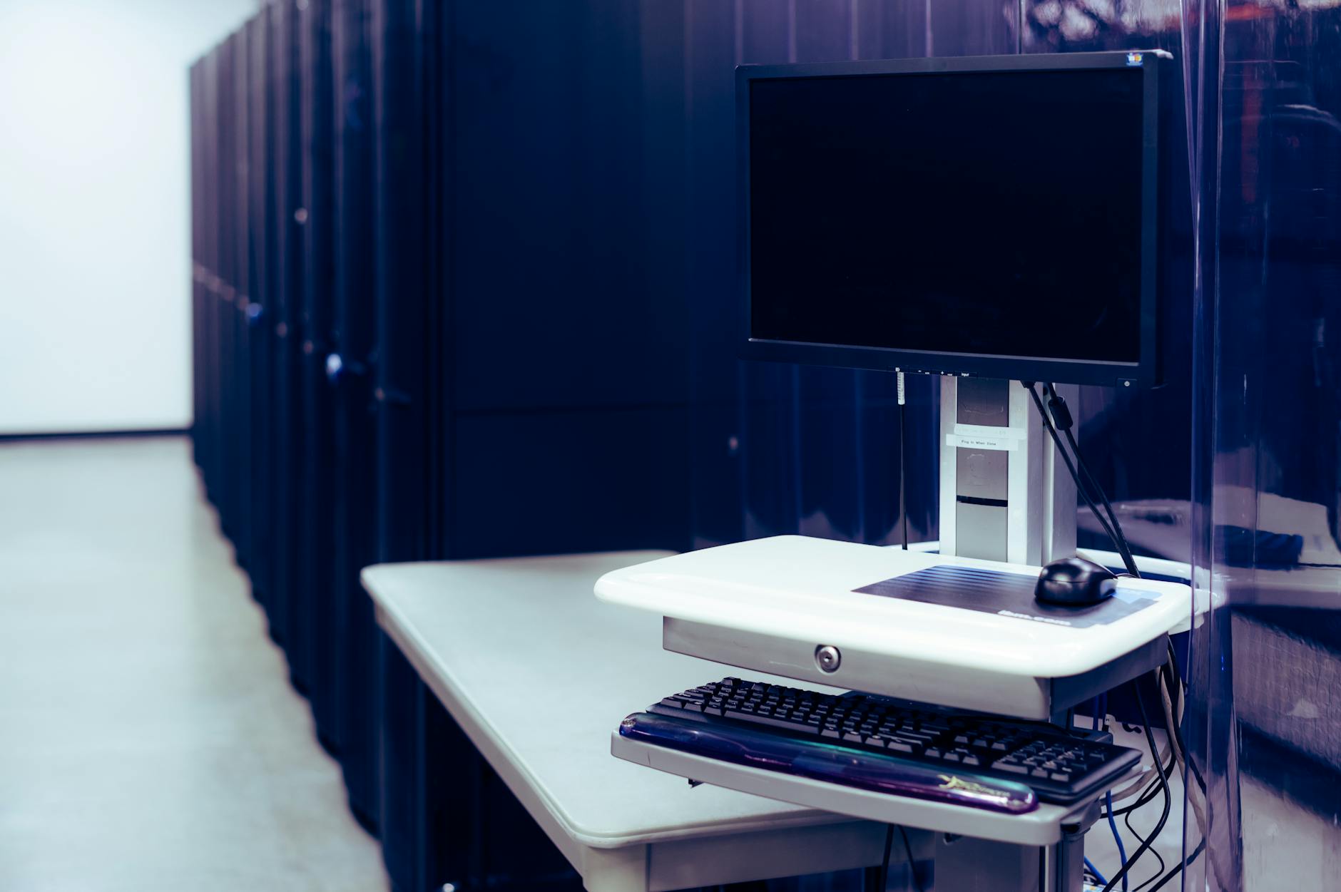 Rows of illuminated server racks in a modern data center facility