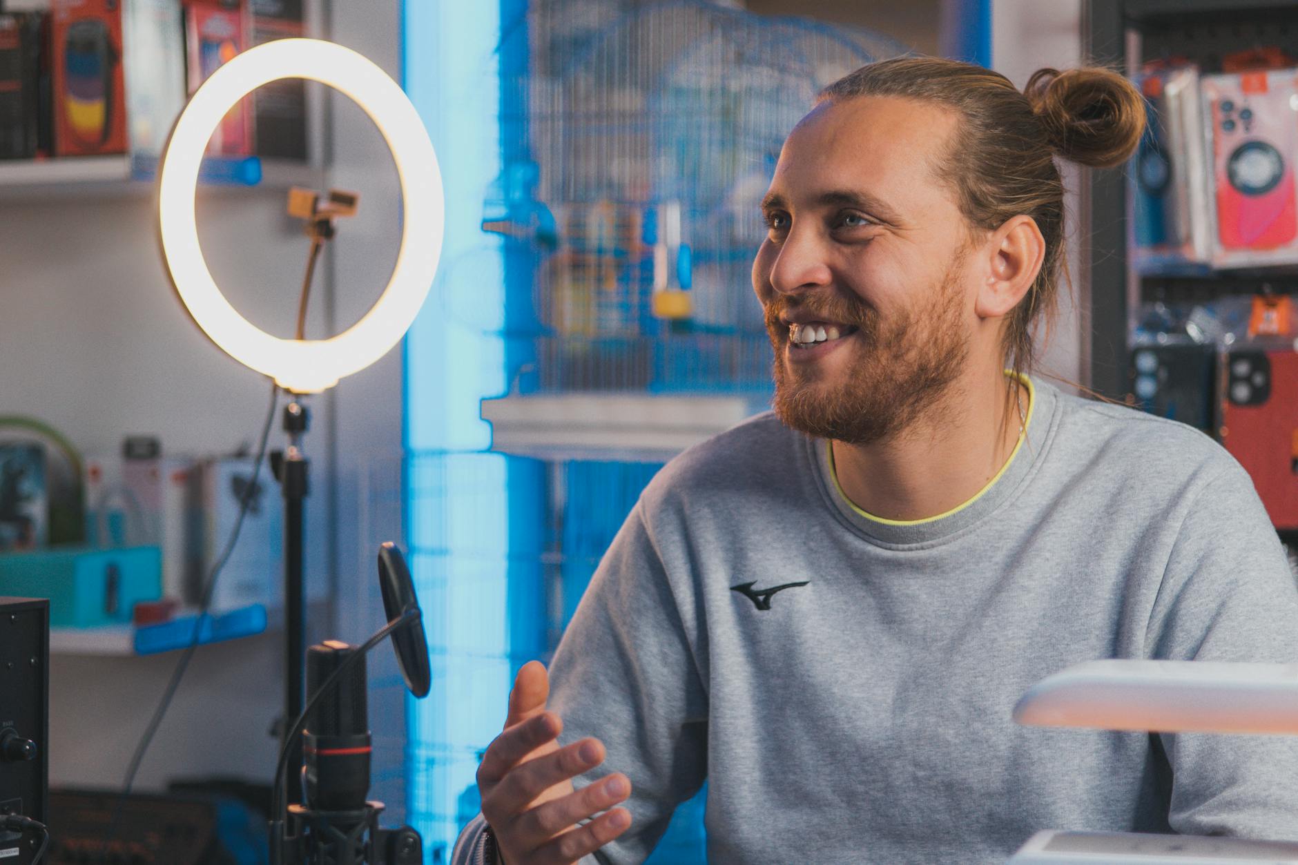 Content creator recording video in professional studio setup with lighting and camera equipment