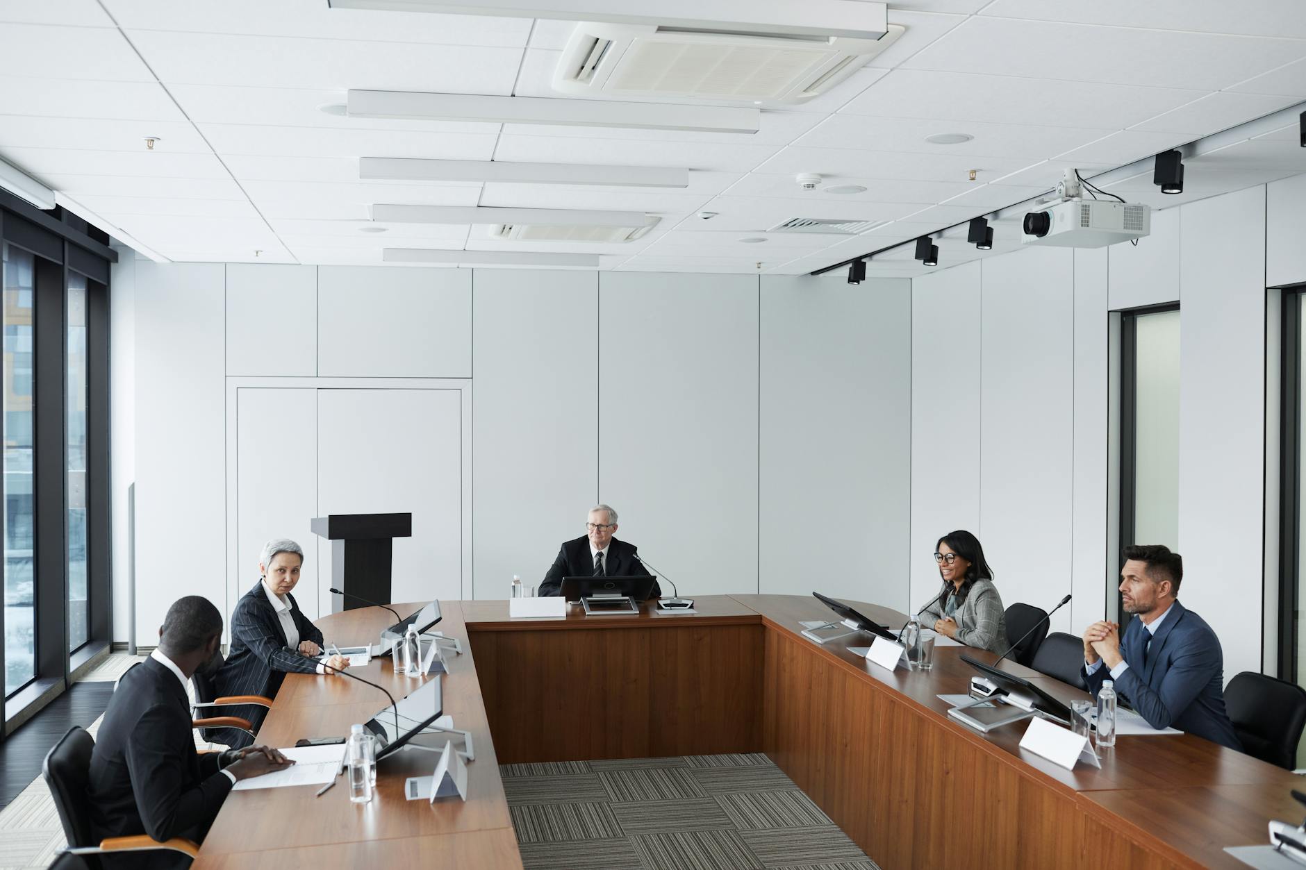 Professional financial advisor meeting with clients to discuss investment strategies and portfolio allocation