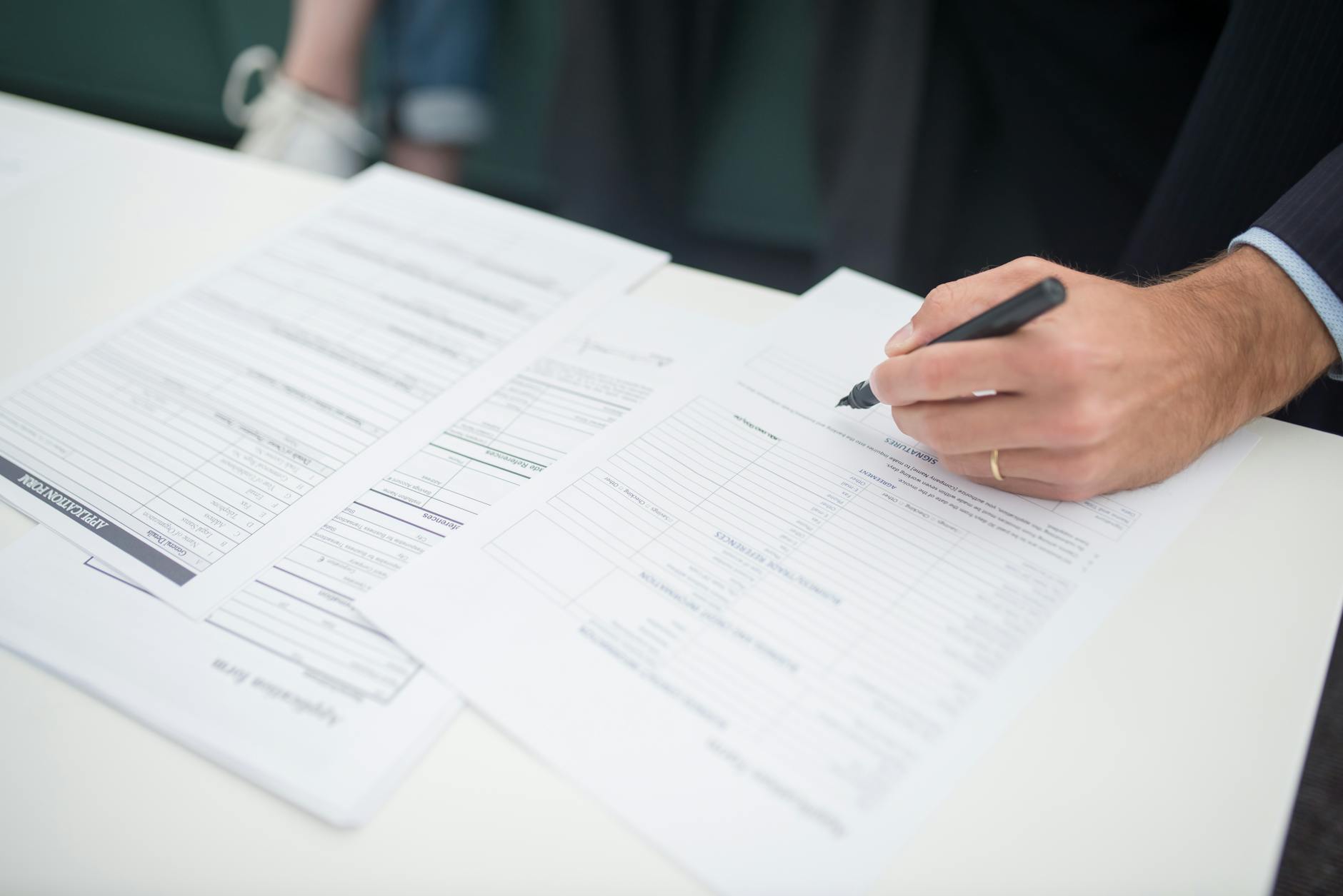 Business insurance policy documents and calculator showing rising premium calculations
