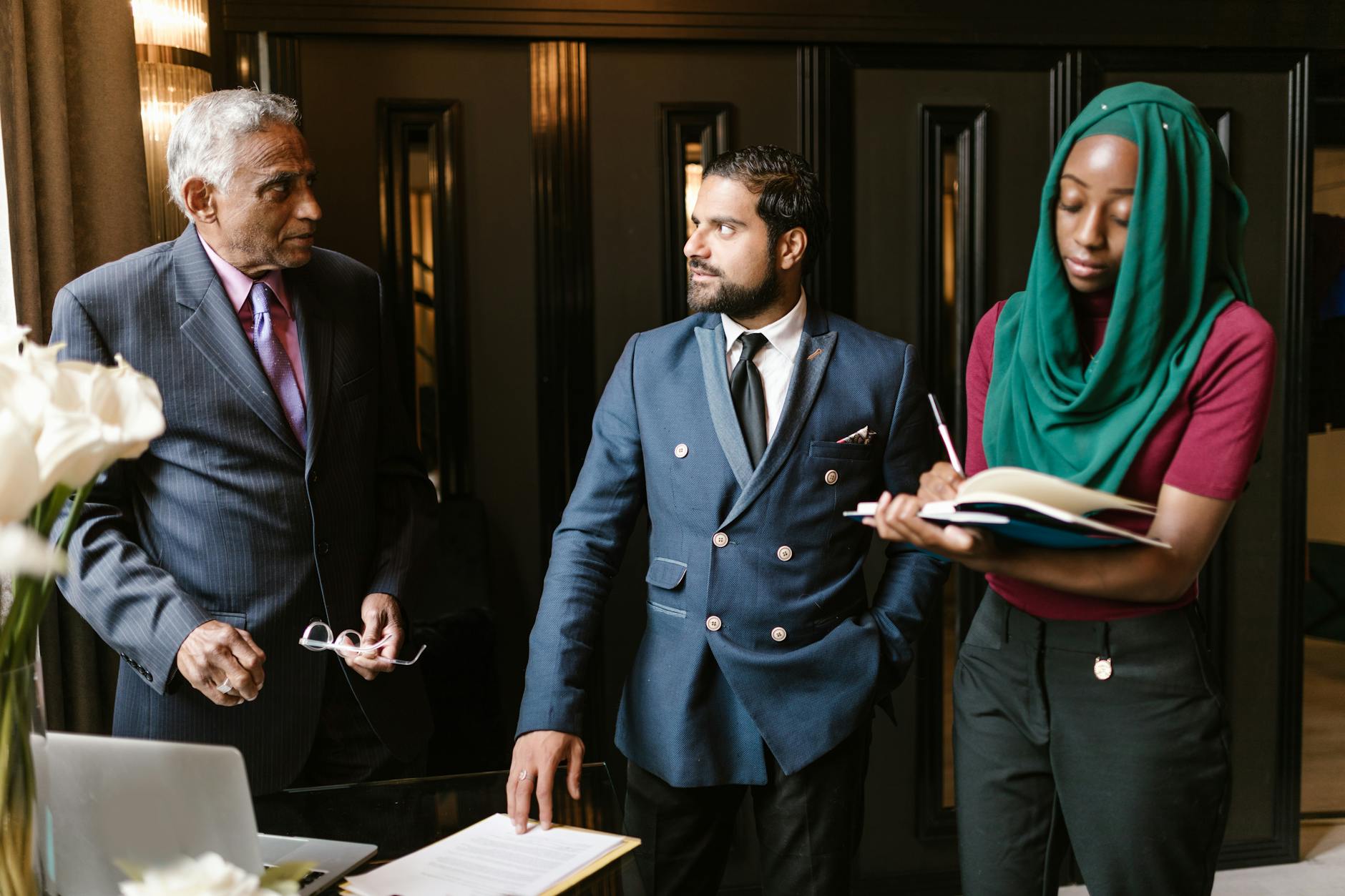 Group of diverse small business owners discussing financial solutions in modern office setting