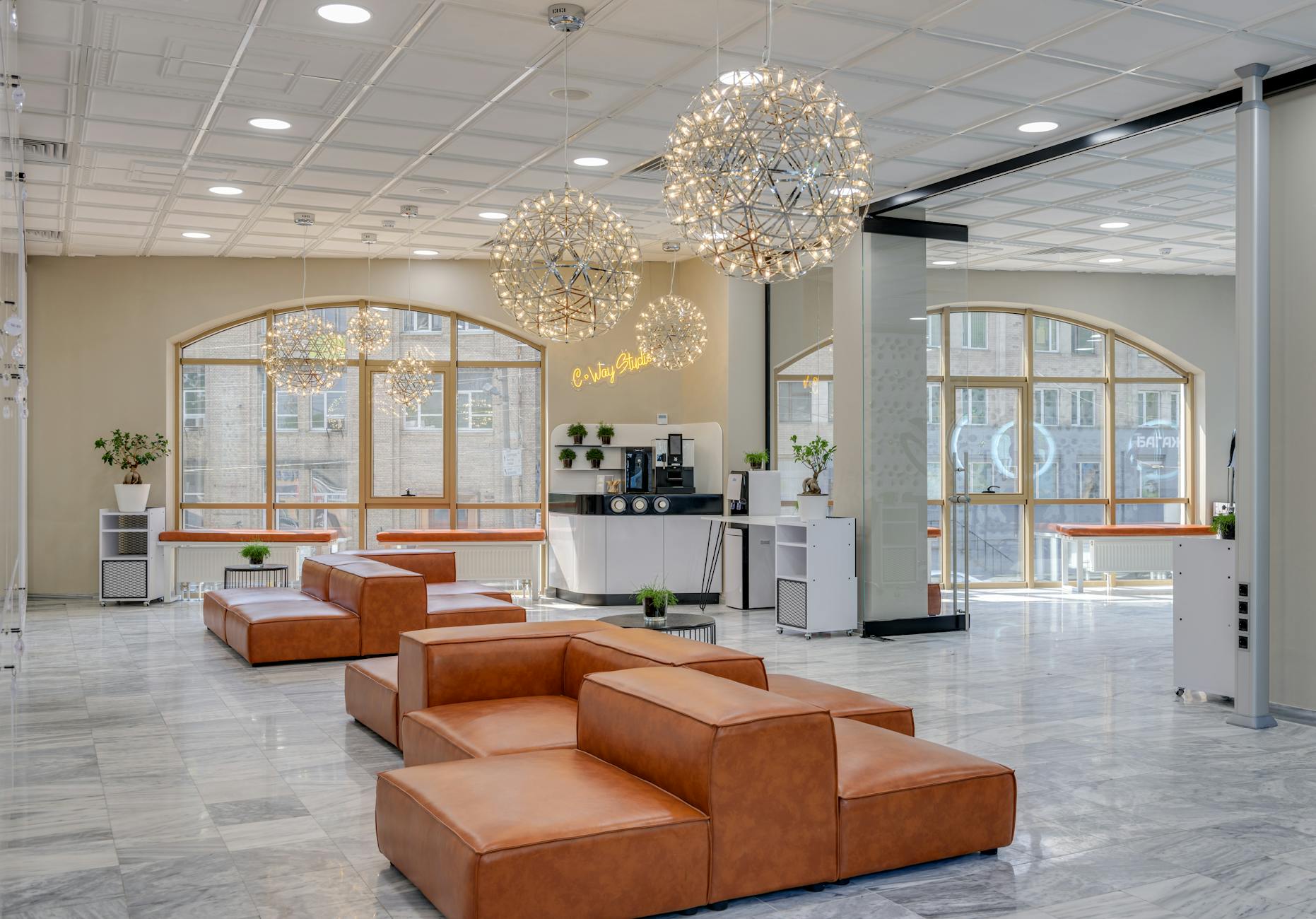 Modern coworking space with people working on laptops in a bright, open environment