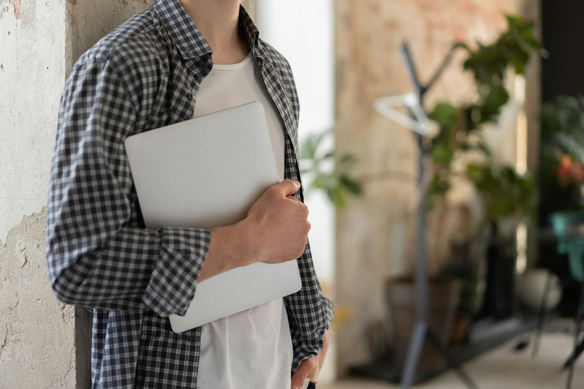 Young adult working on laptop managing personal finances and savings