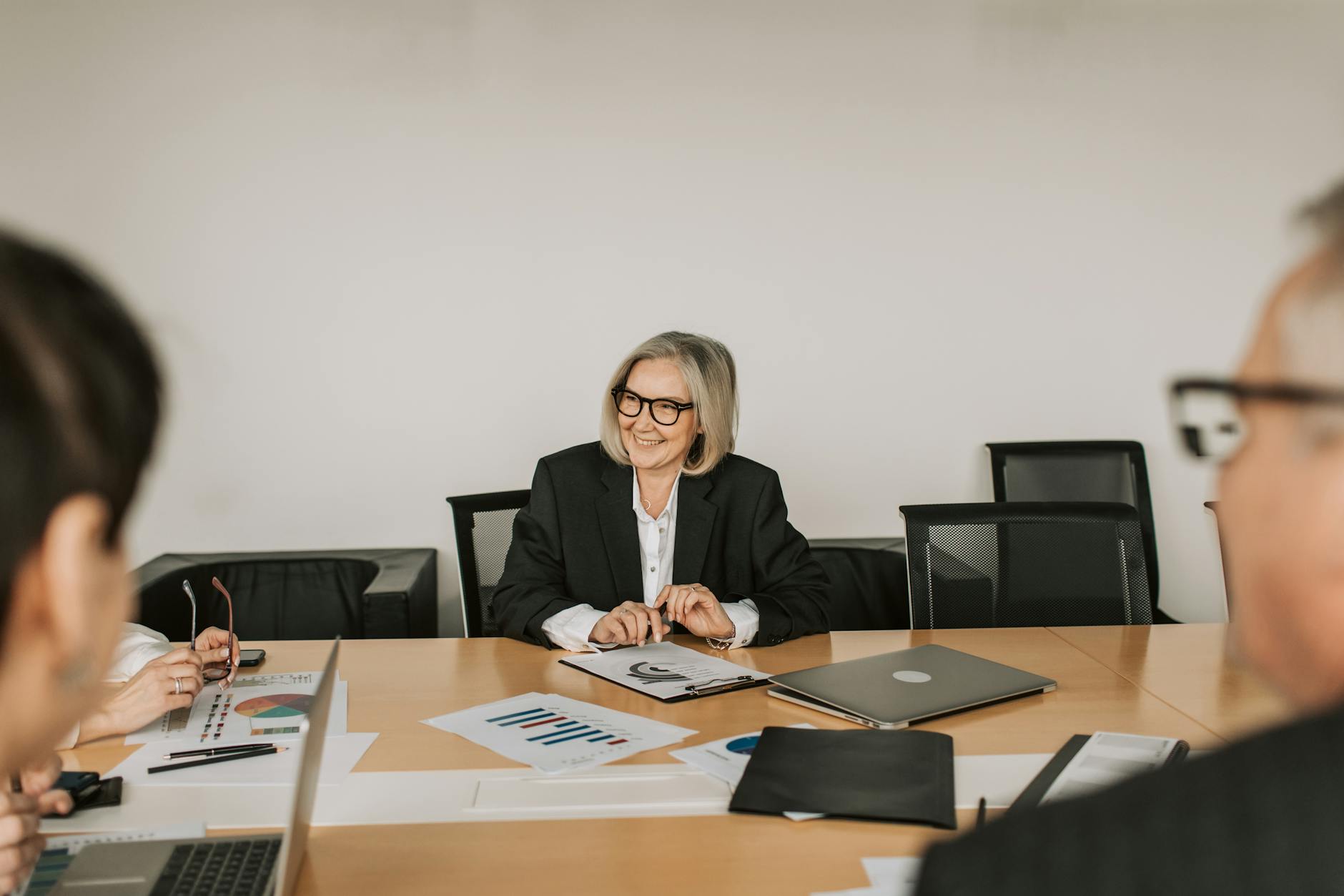 Business executives in boardroom meeting discussing financial strategies