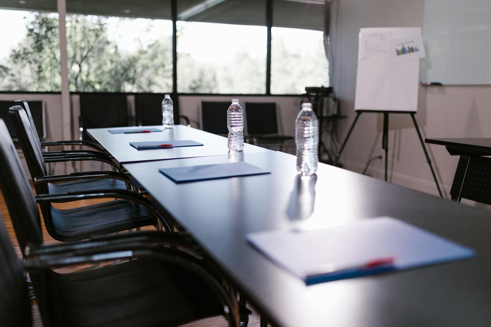 Professional meeting room setup with conference table and presentation screen
