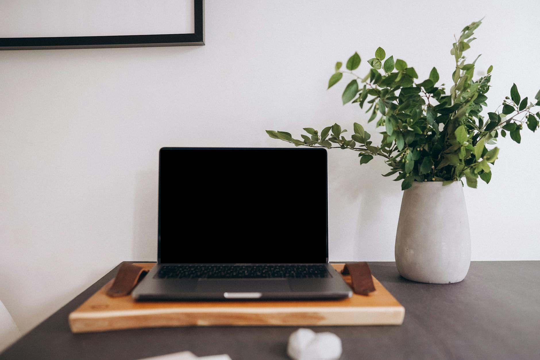 Home office setup with laptop and documents representing the shift to remote work