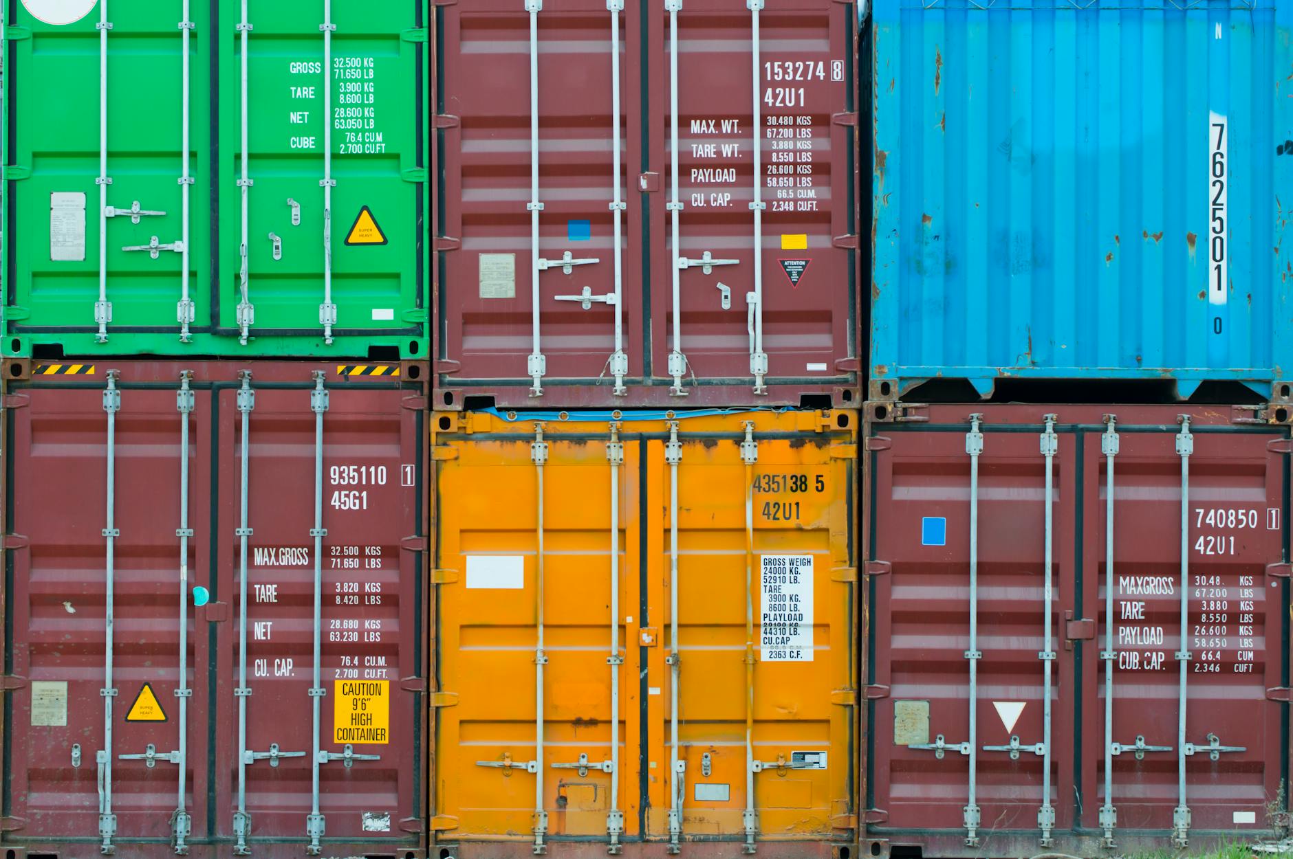 Stacked shipping containers at port facility showing supply chain infrastructure