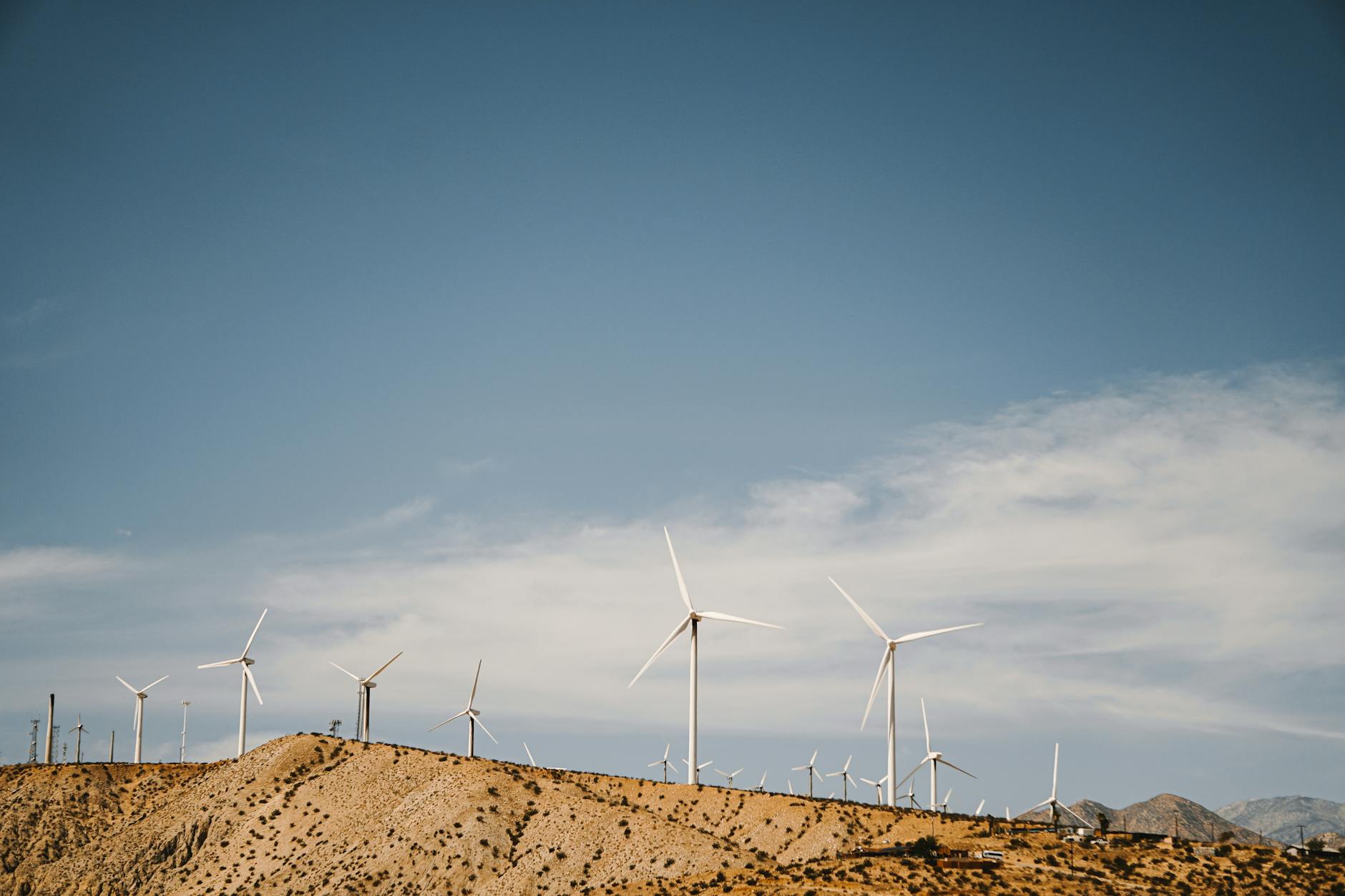 Solar panels and wind turbines representing clean energy infrastructure investments