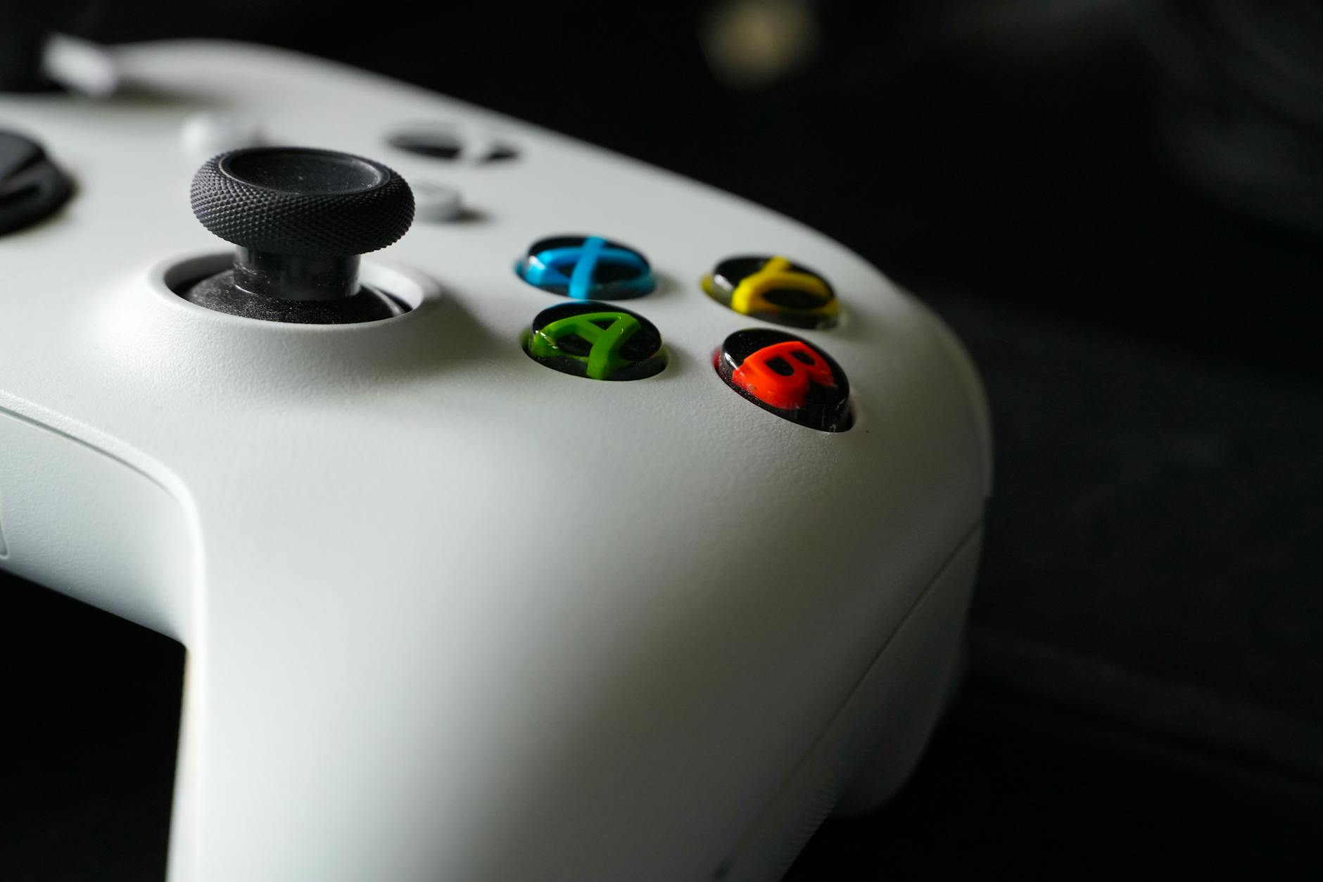 Modern gaming controller on dark surface representing interactive entertainment technology