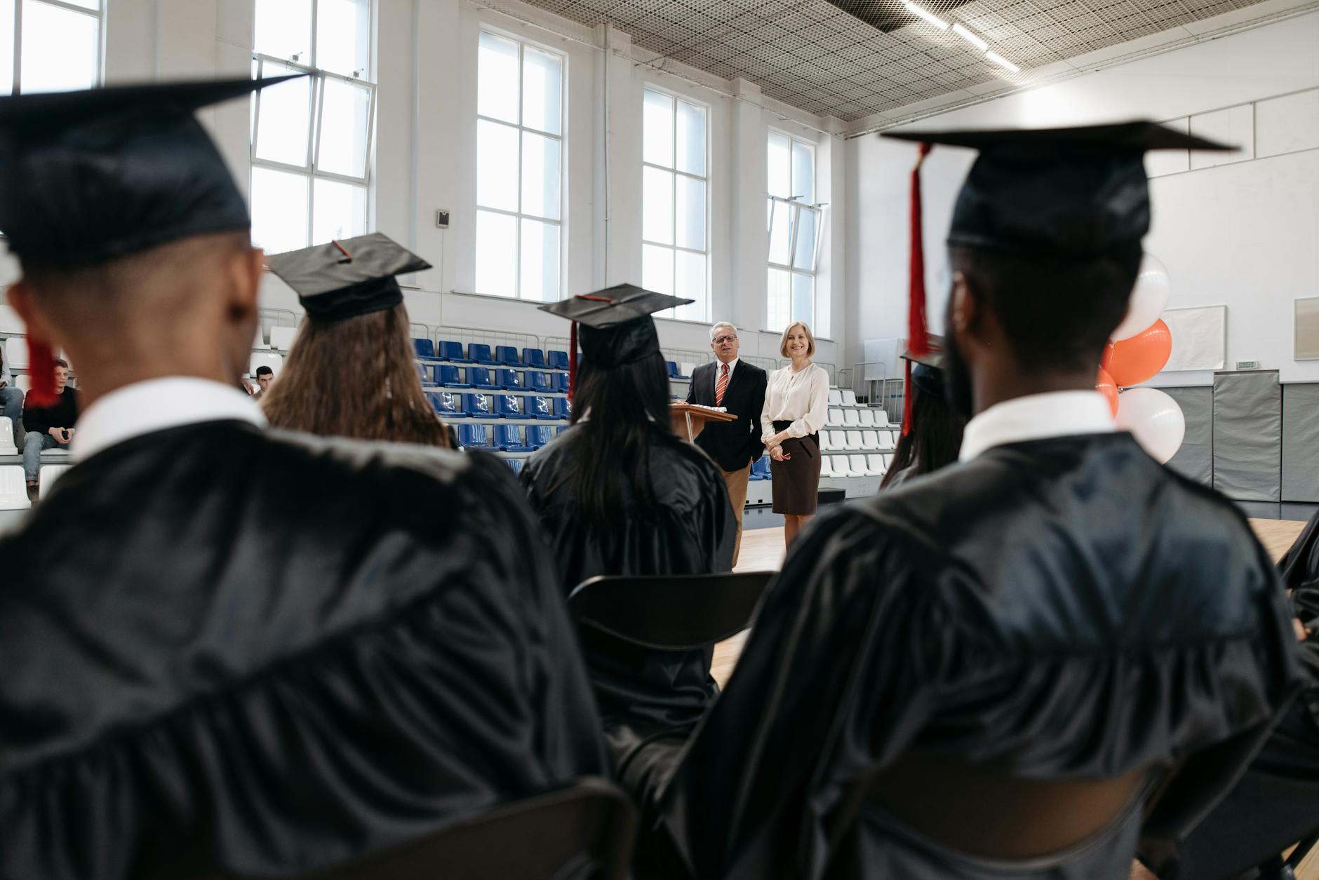 Young graduate in cap and gown representing children reaching age of majority to access UTMA account funds