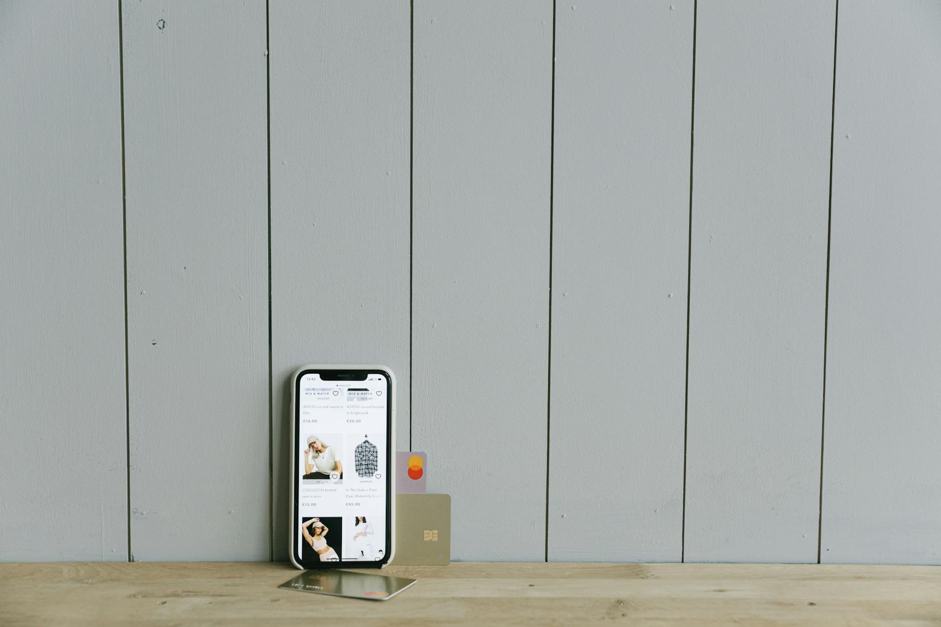 Person using mobile banking app on smartphone with financial charts