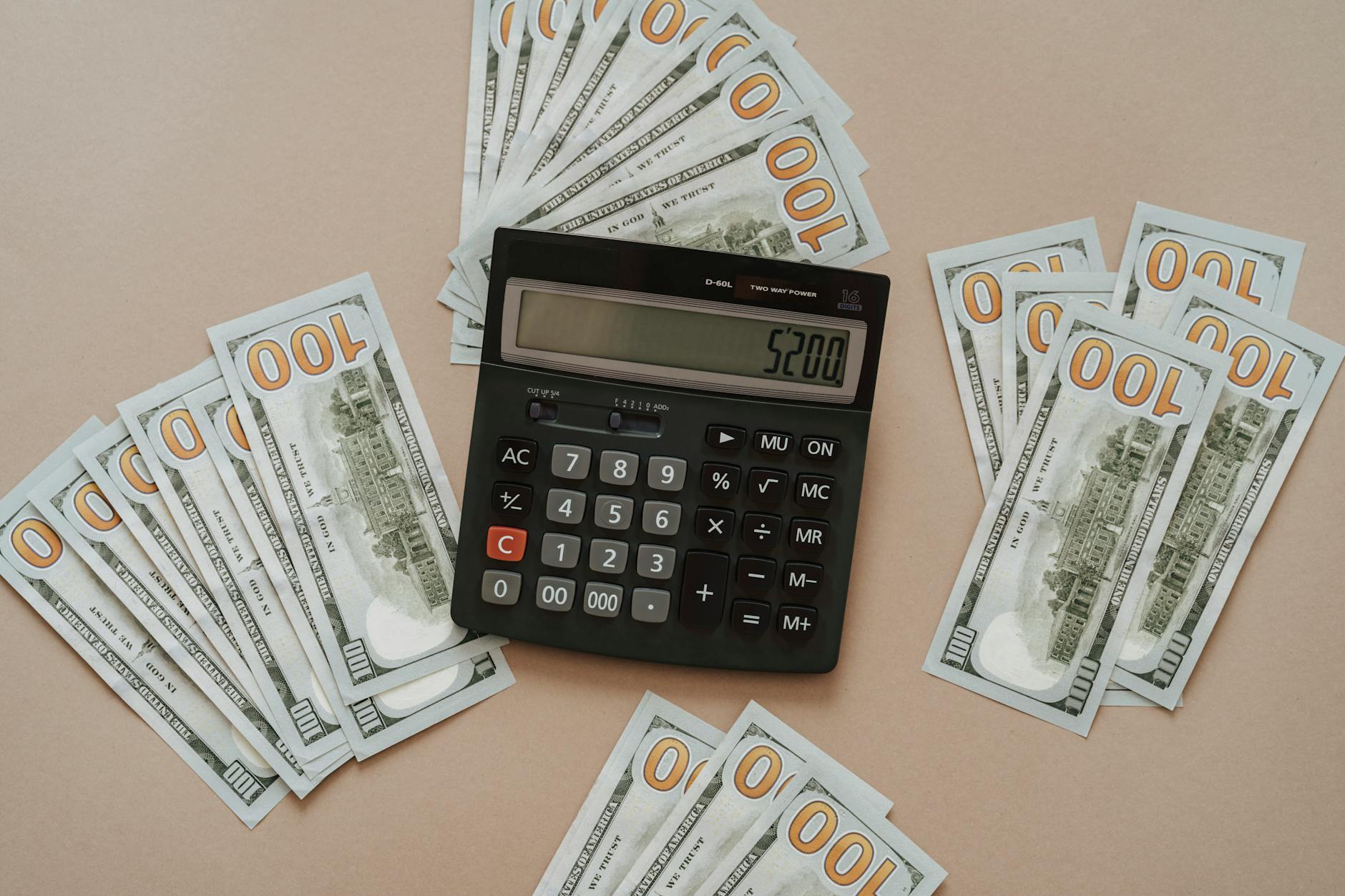 Calculator with paper money and bills showing financial planning and budgeting