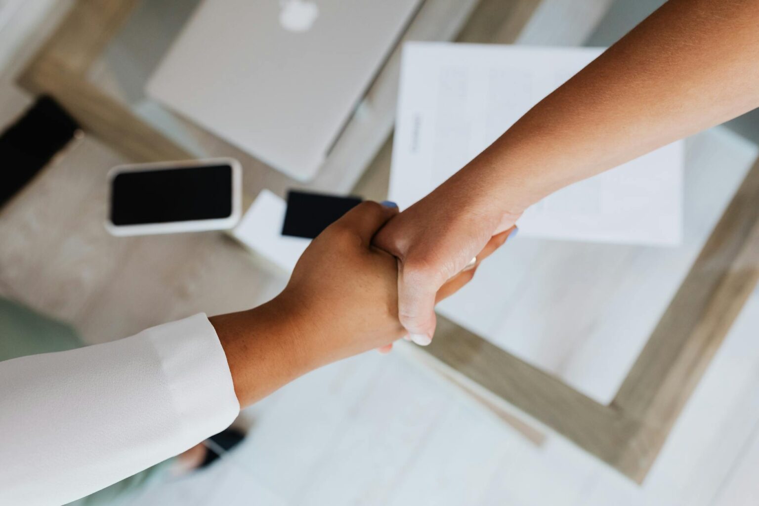 Business professionals shaking hands over investment agreement