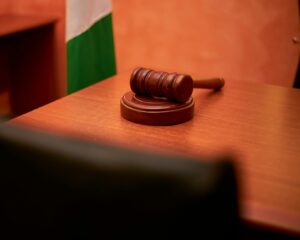 Wooden gavel on judge's bench in empty courtroom