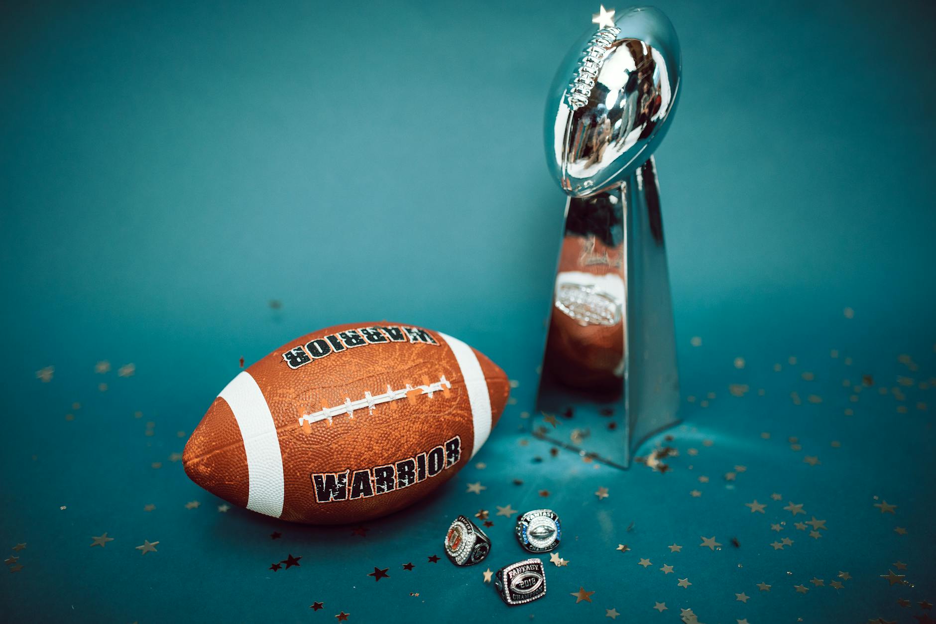 Football and dollar bills representing NFL draft contract values