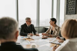 Corporate executives reviewing financial documents in modern office setting