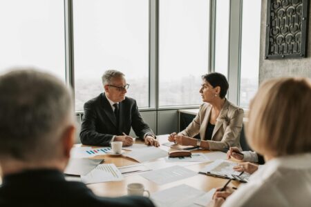 Professional business meeting with executives discussing financial documents