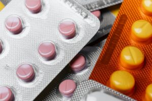 Prescription medication pills and bottles representing pharmaceutical industry