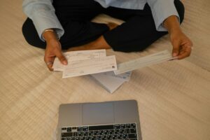 Person reviewing banking documents and statements at desk