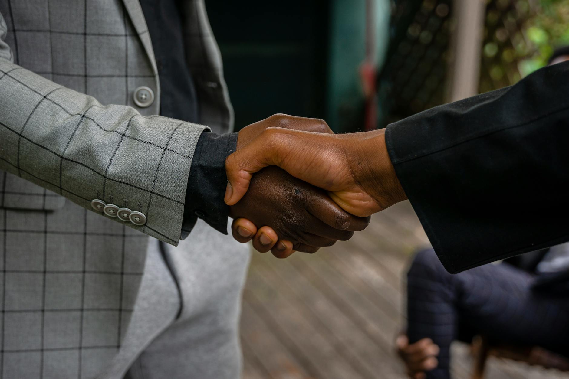 Business professionals shaking hands during corporate partnership meeting