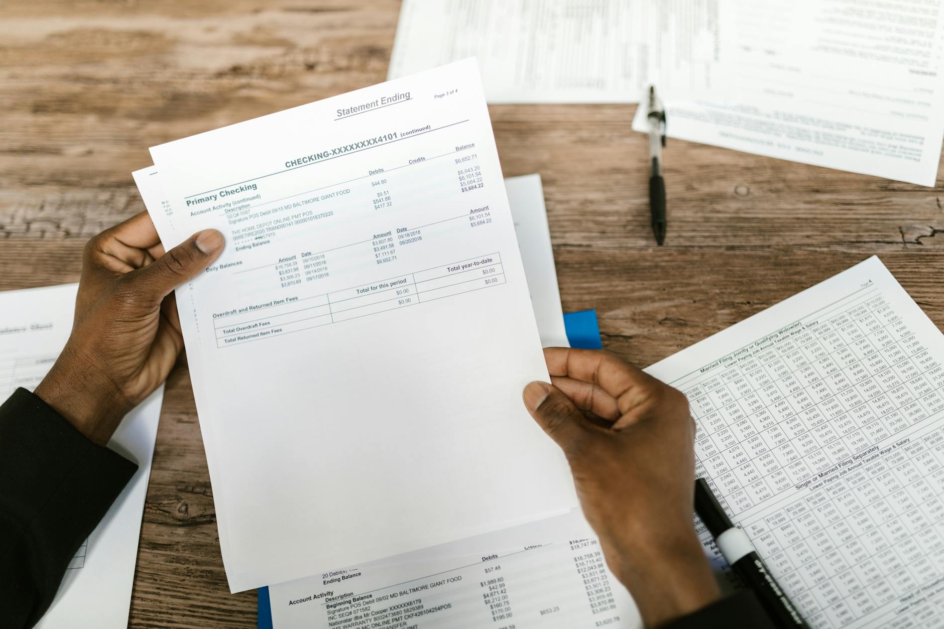 Financial documents and papers on desk during investigation