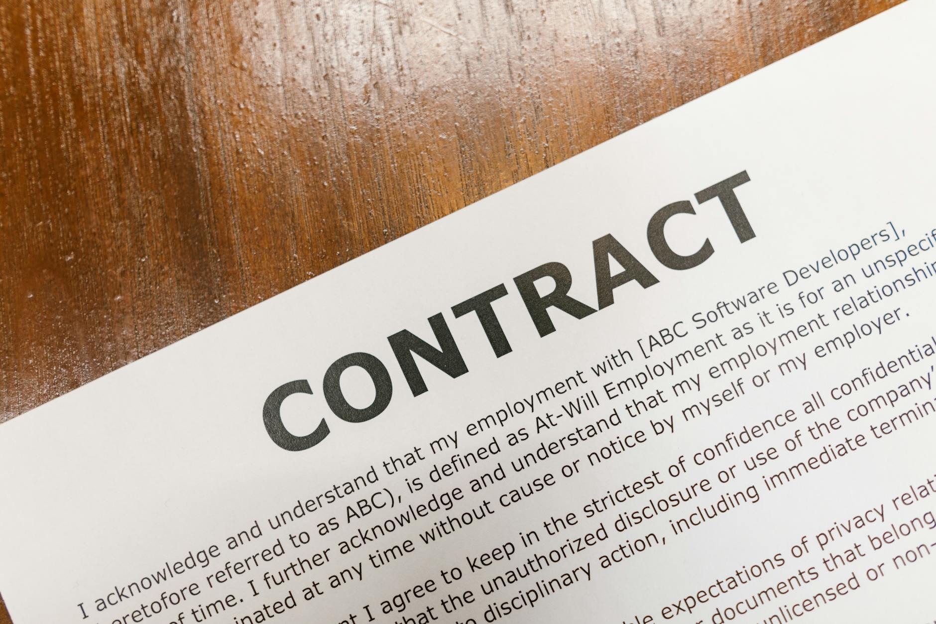 Music industry contract documents on desk with pen