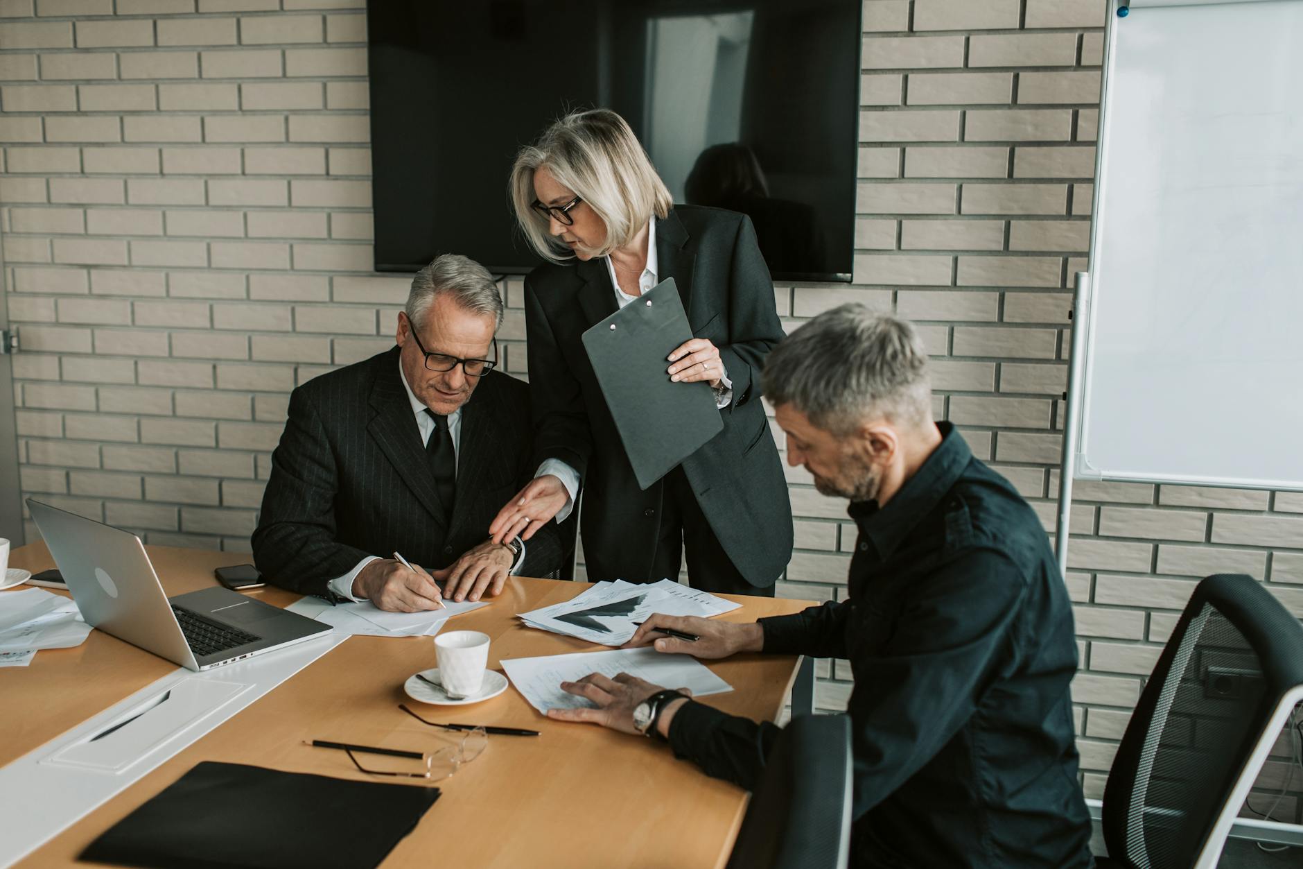 Business executives discussing investment strategies in conference room