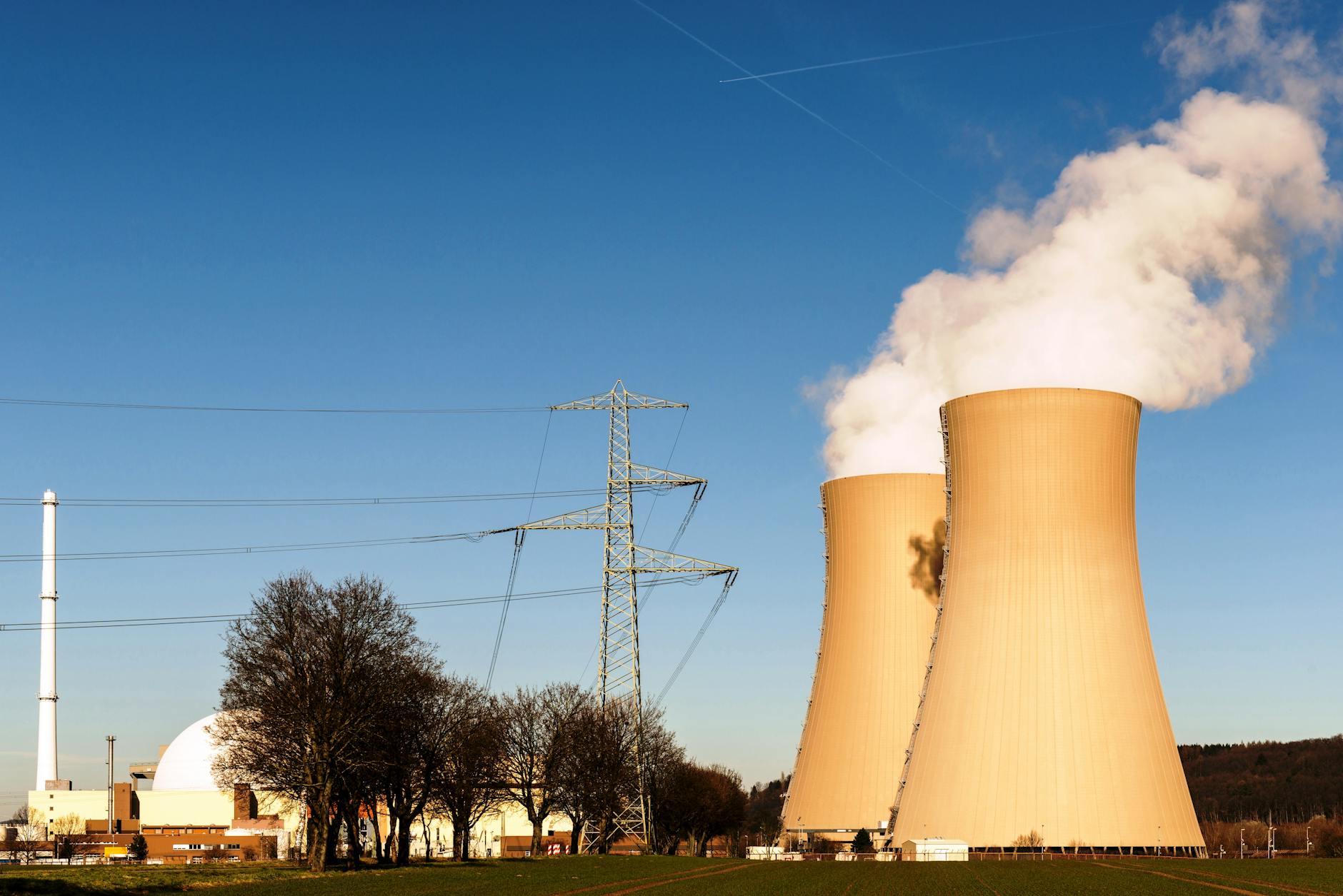 Nuclear power plant cooling towers against blue sky