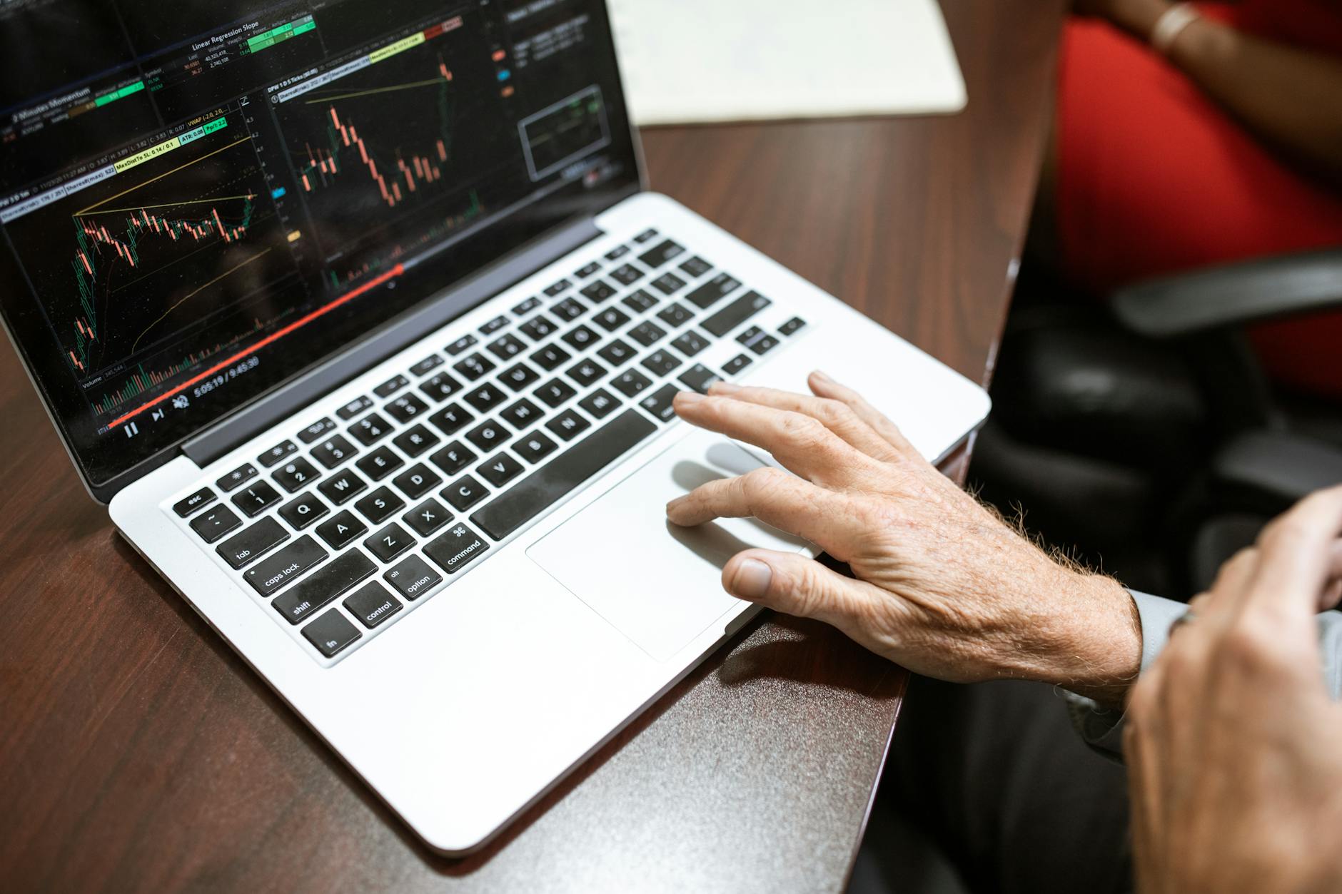 Financial technology setup with multiple computer monitors displaying trading charts