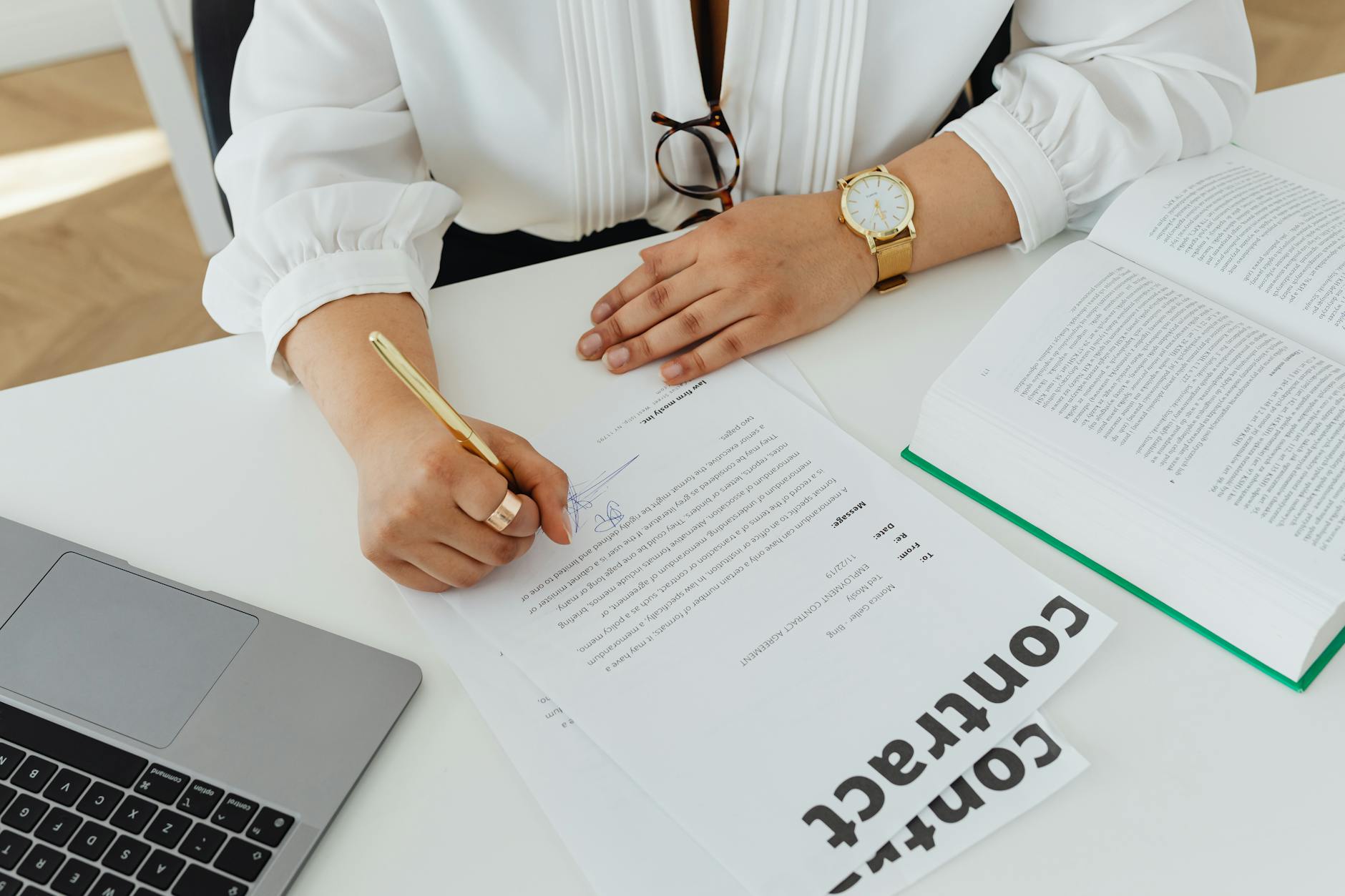 Business professional signing important contract documents