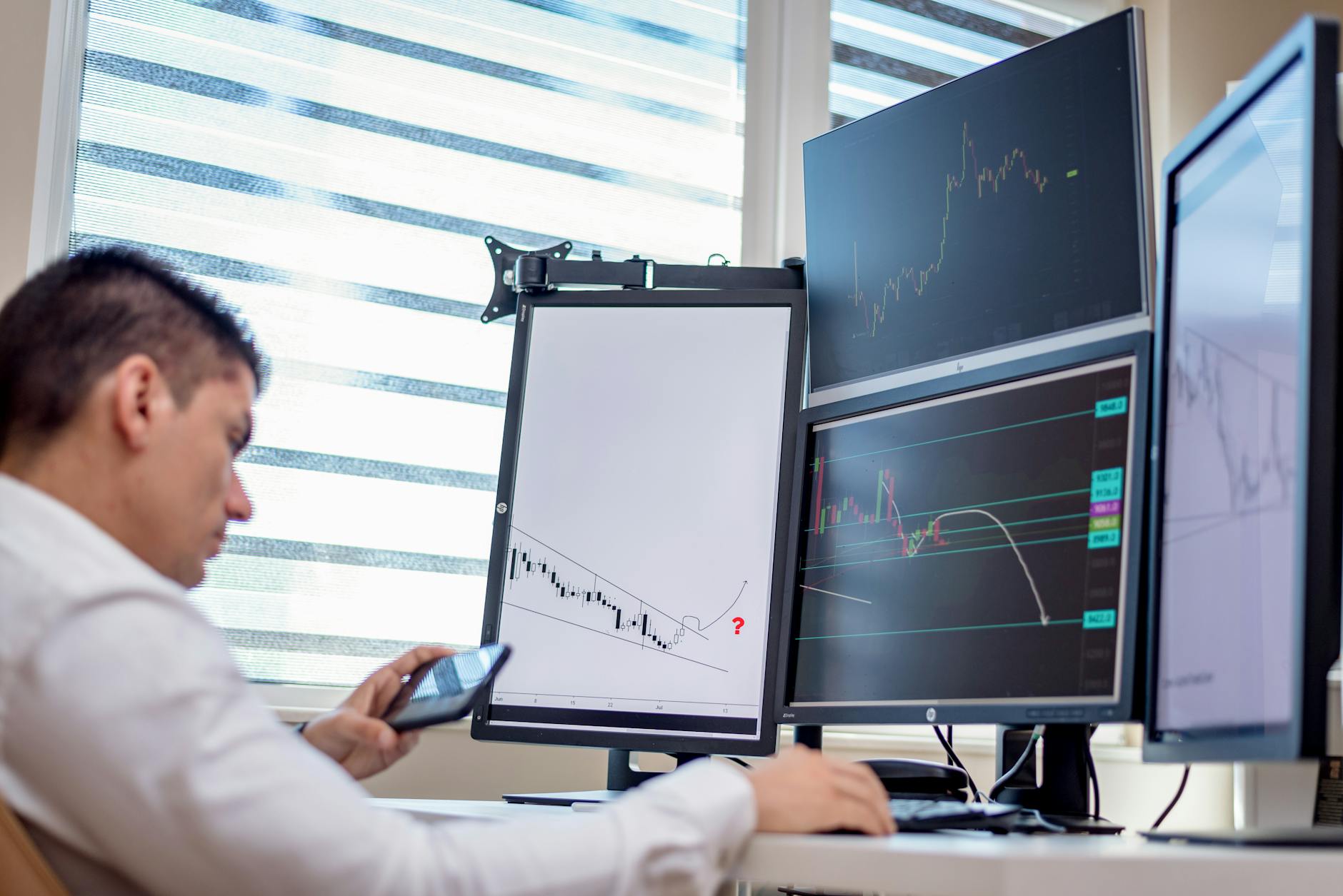 Technology trading setup with multiple computer monitors showing market data