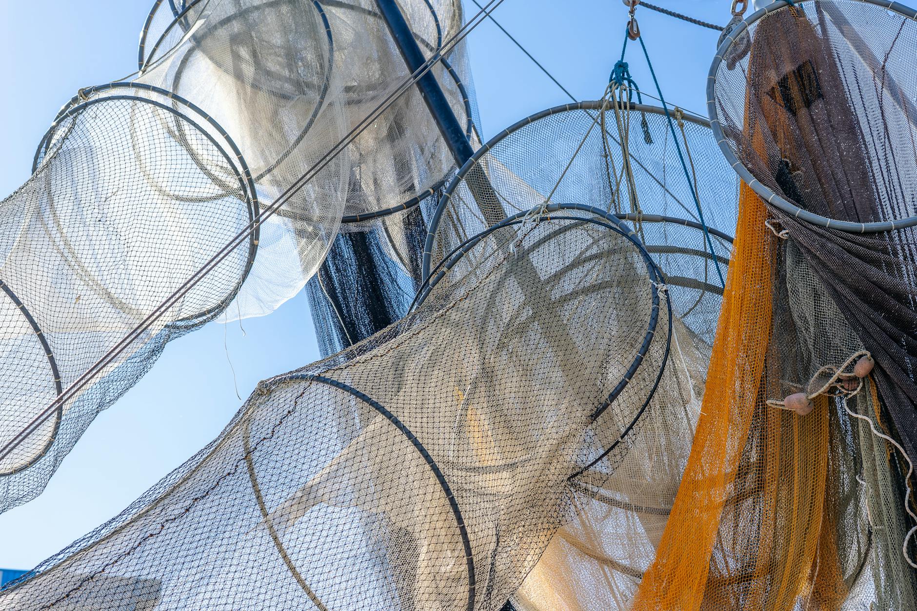 Large fishing nets being deployed in water