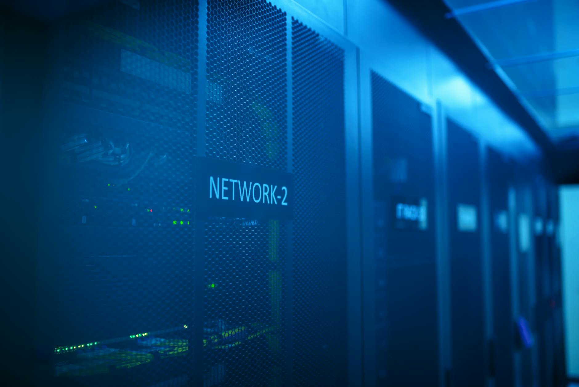 Modern data center server room with blue lighting and equipment racks