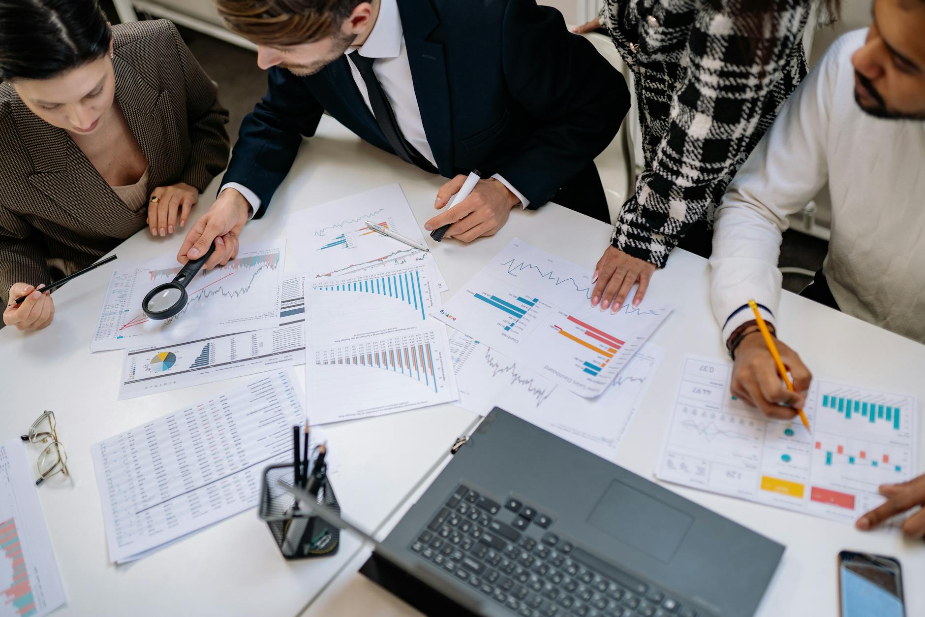 Business professionals analyzing financial charts and market data on computer screens