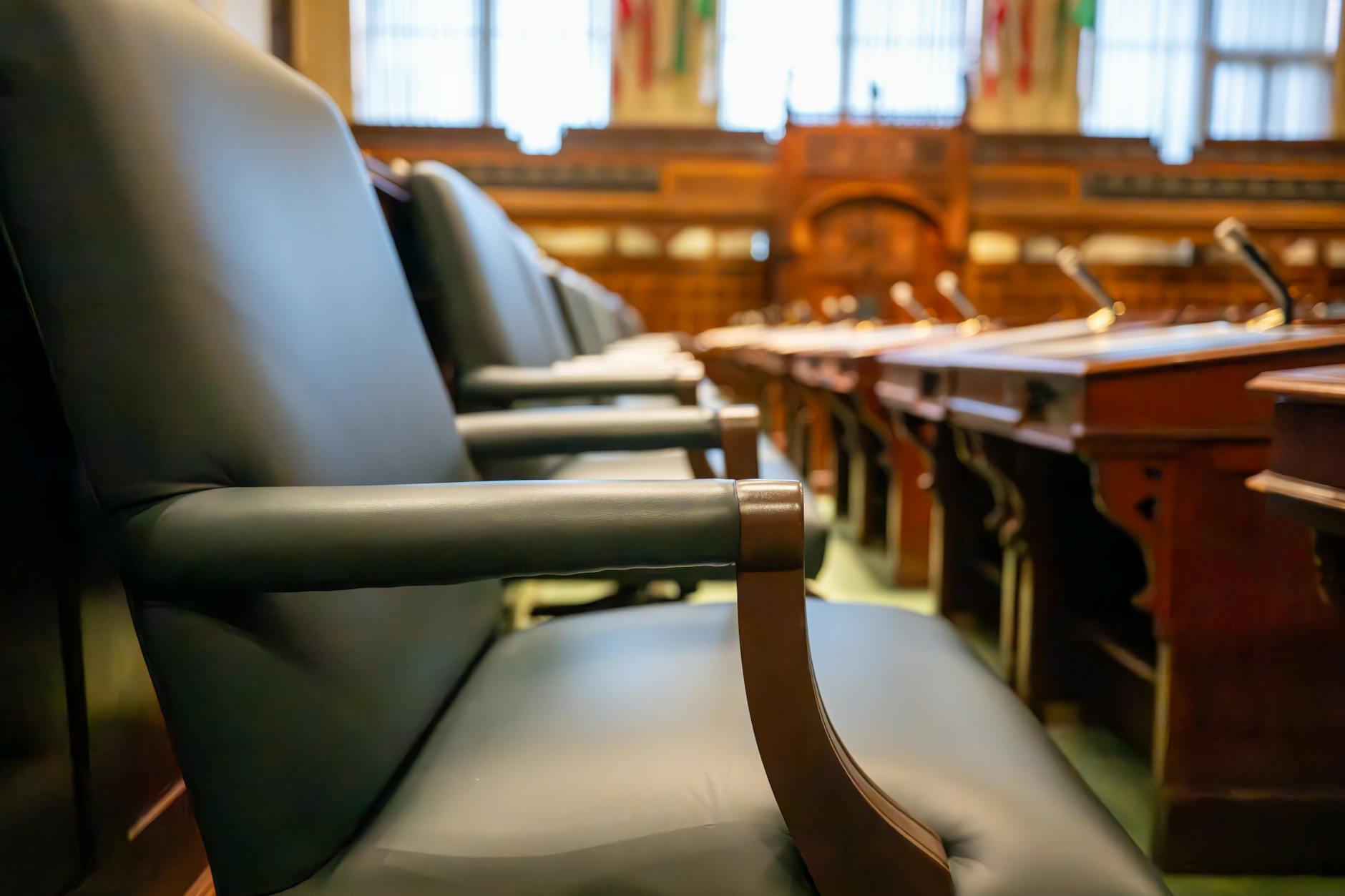 Congressional hearing room with witness table and microphones