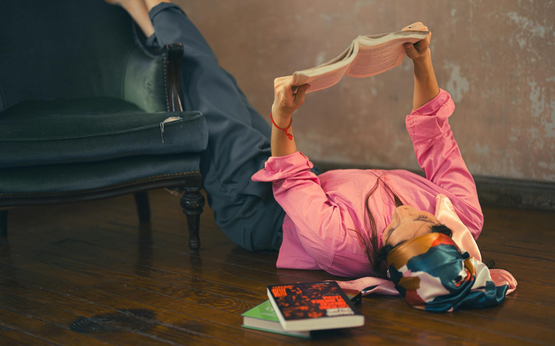 Woman reading book in comfortable chair
